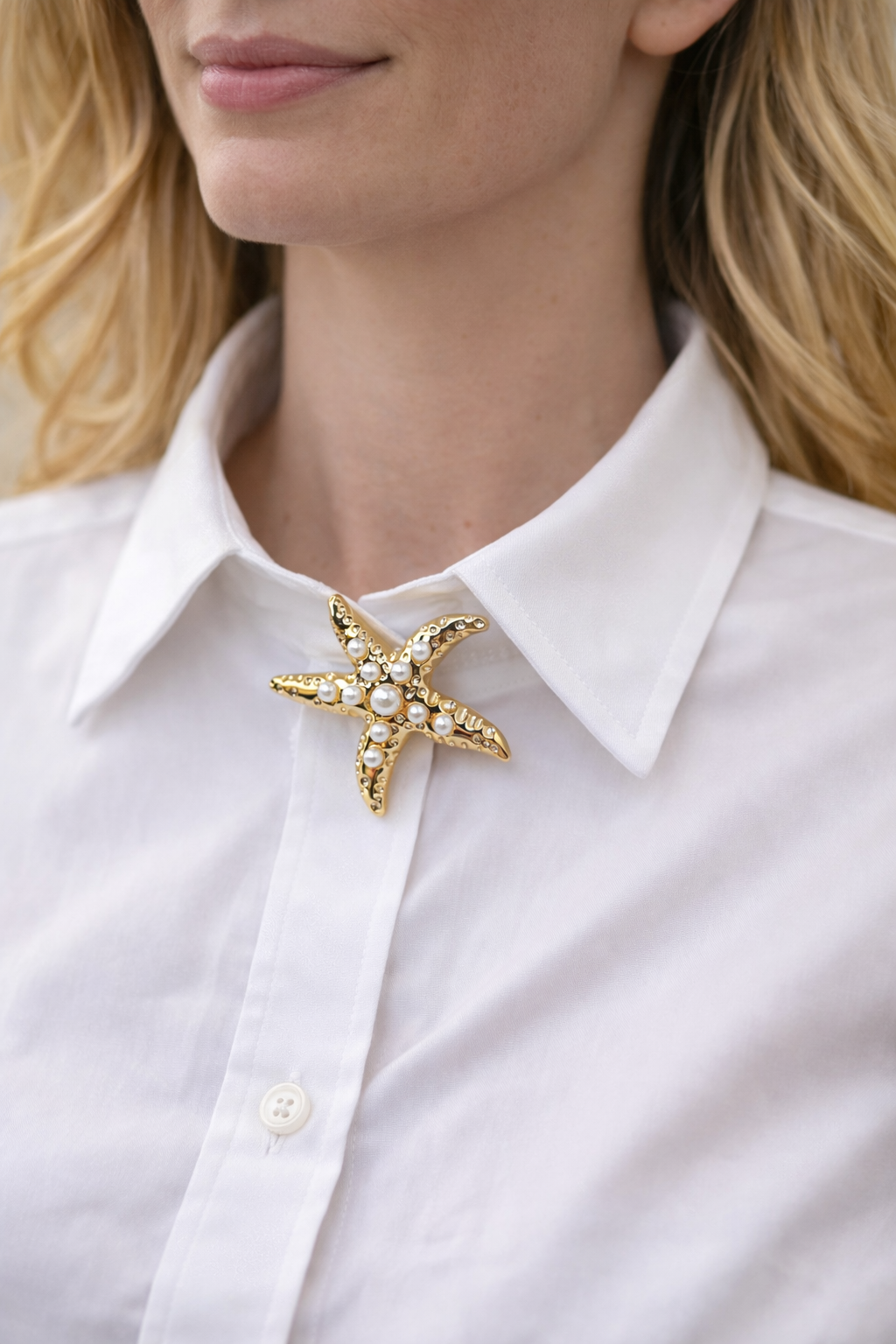 Starfish-shaped brooch on a white shirt