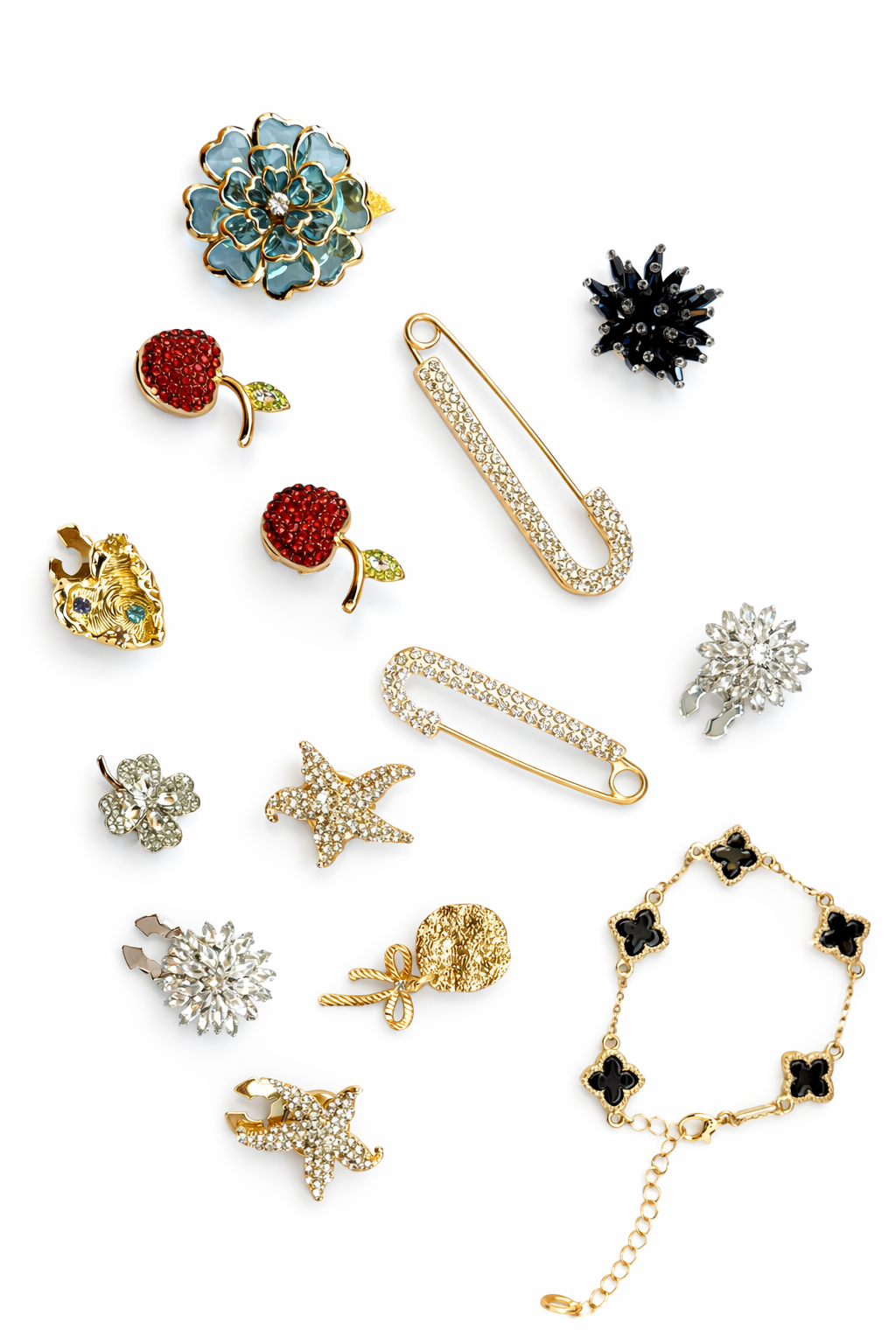 Collection of various jewelry items including brooches and a bracelet on a white background